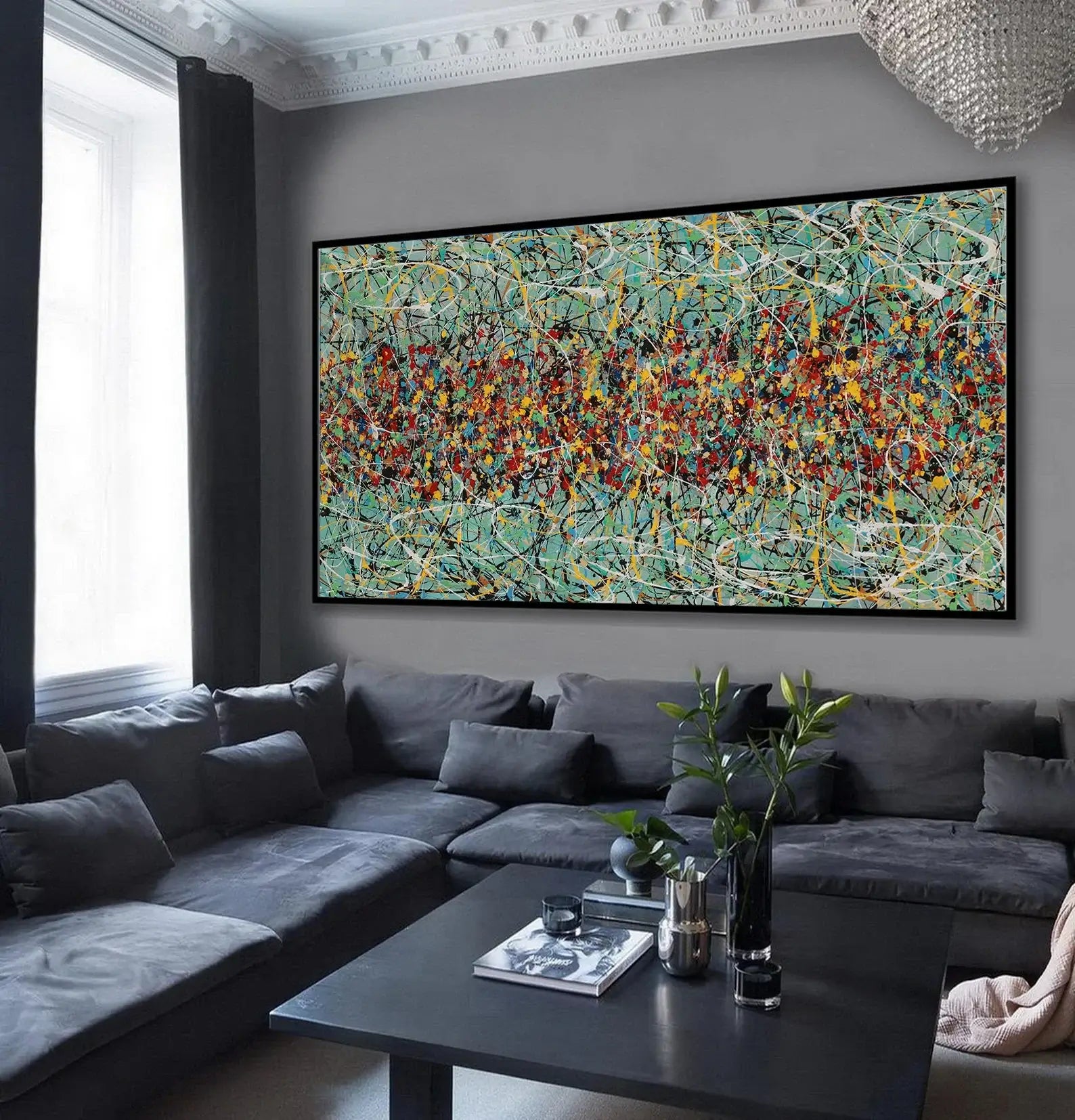 Drip painting on canvas showcasing vibrant colors and dynamic patterns in a modern living room setting.