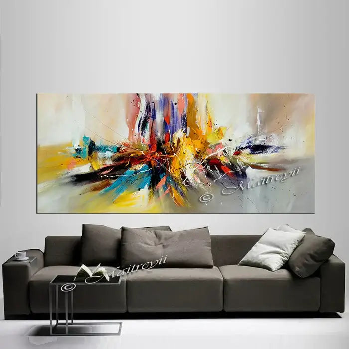 Large modern abstract oil painting above a stylish gray sofa, featuring vibrant colors and dynamic textures.