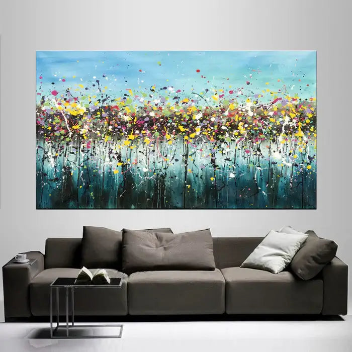 Large Modern Art featuring vibrant Jackson Pollock Style colors in a contemporary setting with a stylish sofa.