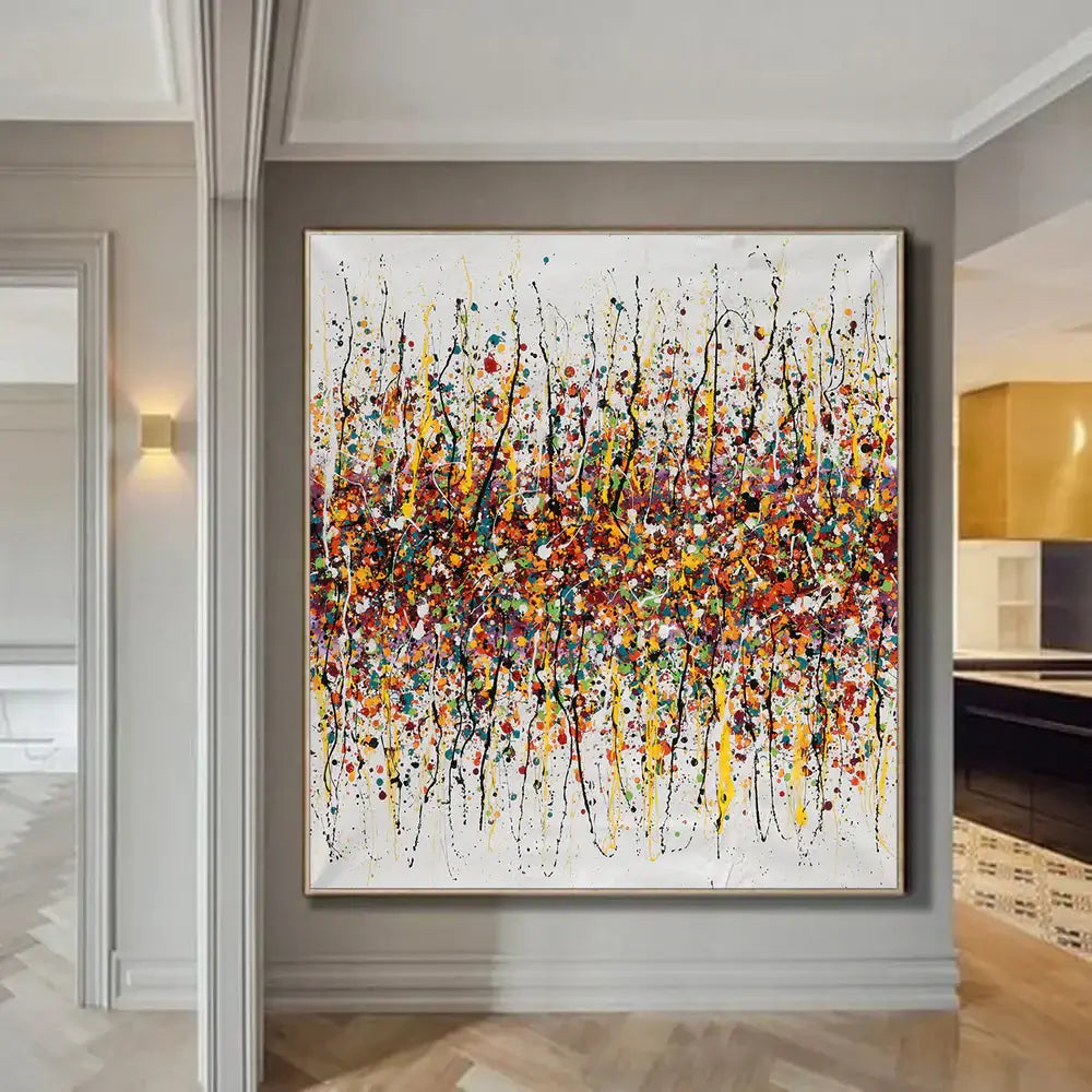 Splatter painting wall decor featuring vibrant colors and dynamic patterns in a modern interior setting.