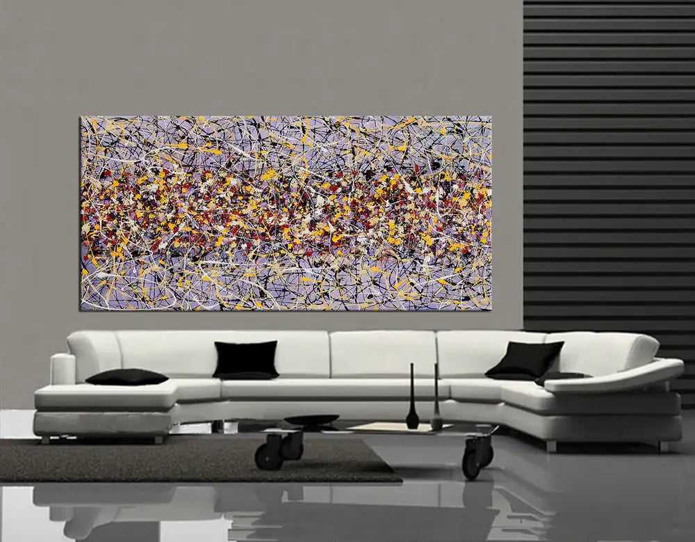 Action painting abstract art on canvas displayed above a modern white sofa in a contemporary living room.