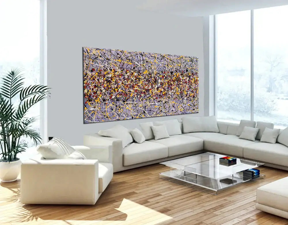 Action painting abstract art displayed in a modern living room, showcasing bold colors and dynamic patterns on canvas.