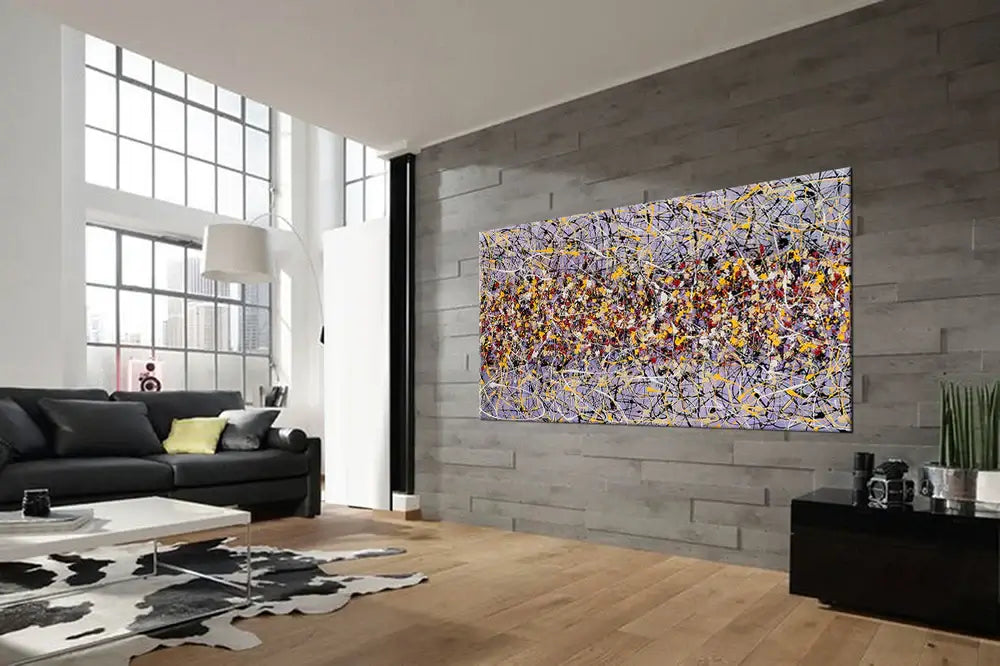 Action painting abstract art displayed in a modern living room with large windows and stylish decor.