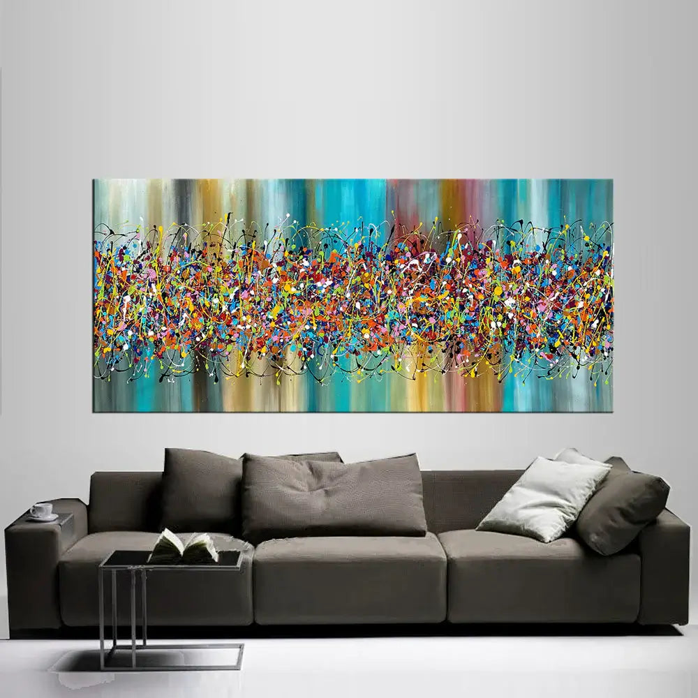 Painting Jackson Pollock style artwork displayed above a modern sofa, showcasing vibrant colors and abstract drip art.