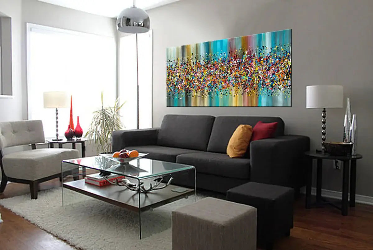 Living room featuring a handmade Painting Jackson Pollock style artwork above a gray sofa, showcasing vibrant colors and abstract designs.