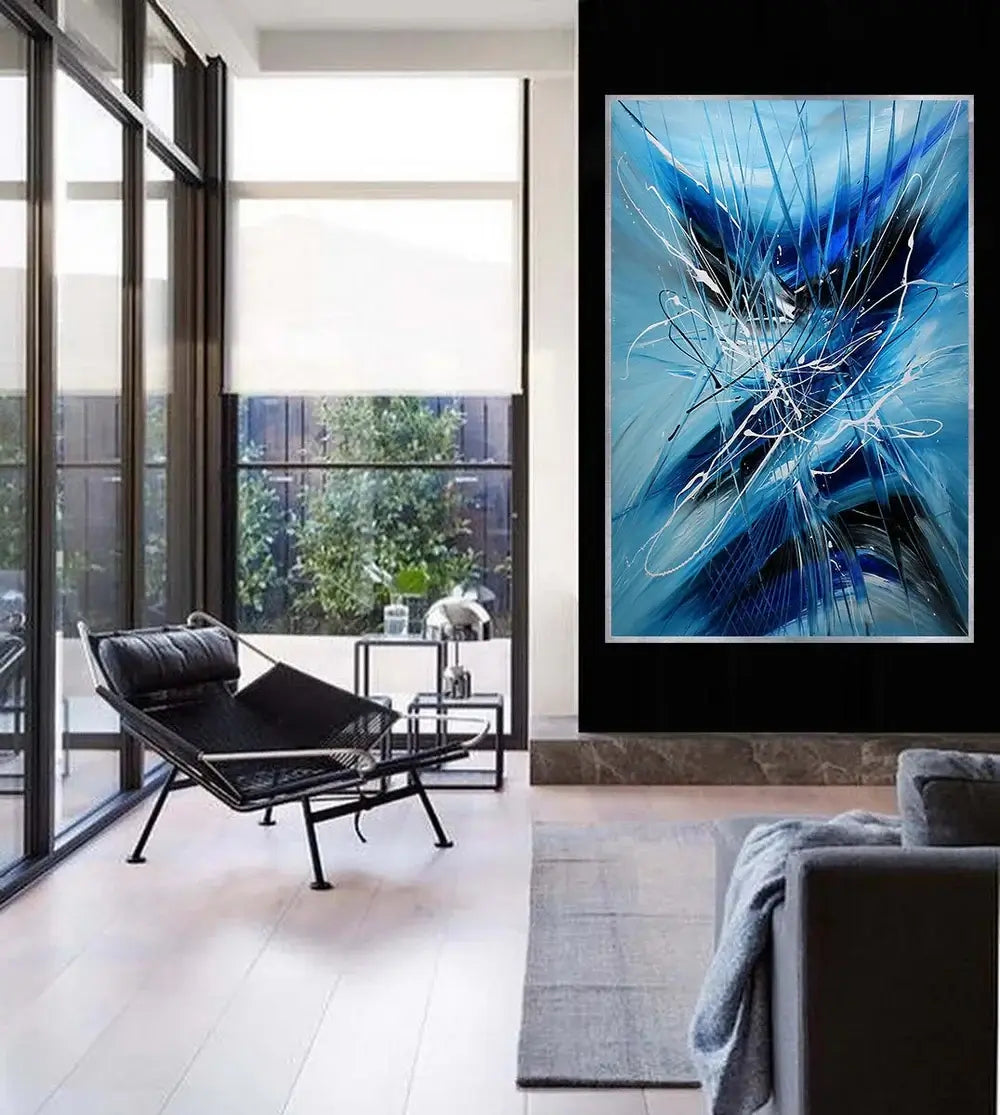 Large Wall Art - Handmade modern abstract canvas painting in blue tones decorating a stylish living room.