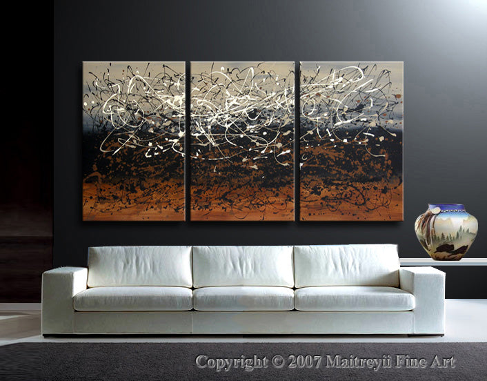Jackson Pollock style painting displayed above a modern white couch in a stylish living room setting.