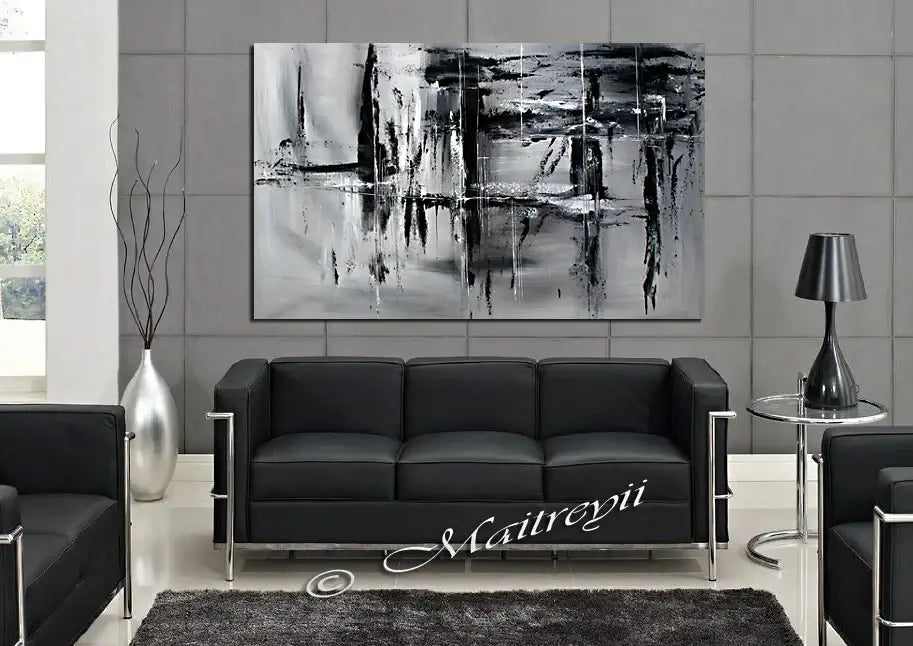 Black and White Large Painting displayed above a modern black sofa in a stylish living room.