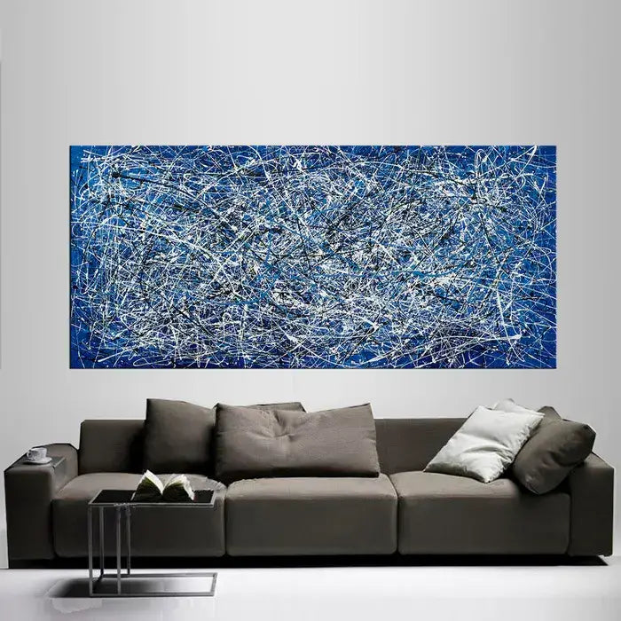 Abstract Angel Paintings in Jackson Pollock style displayed above a modern sofa, showcasing vibrant colors and dynamic brushwork.