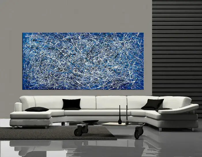 Abstract Angel Paintings in Jackson Pollock style on a wall above a modern white couch in a chic living room.