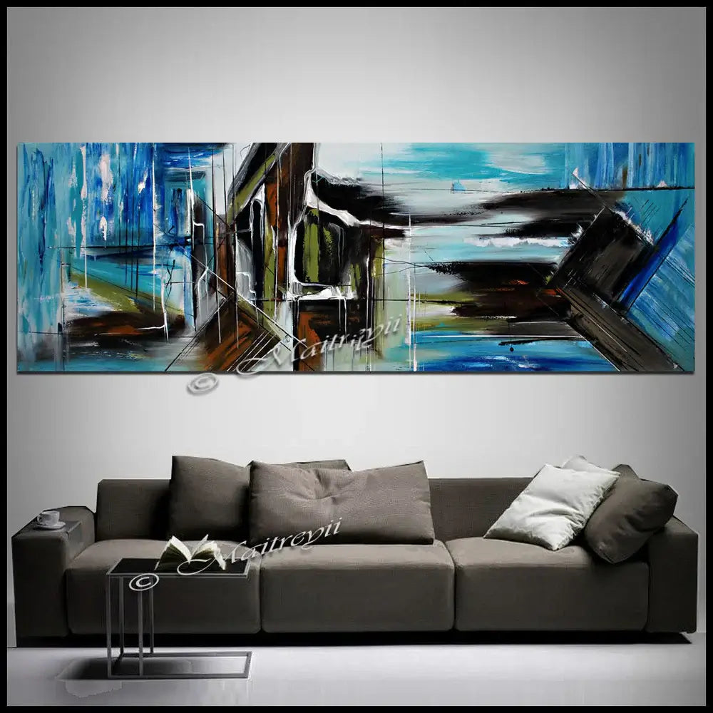 Large Abstract Blue Painting displayed above a modern sofa in a stylish living room setting.