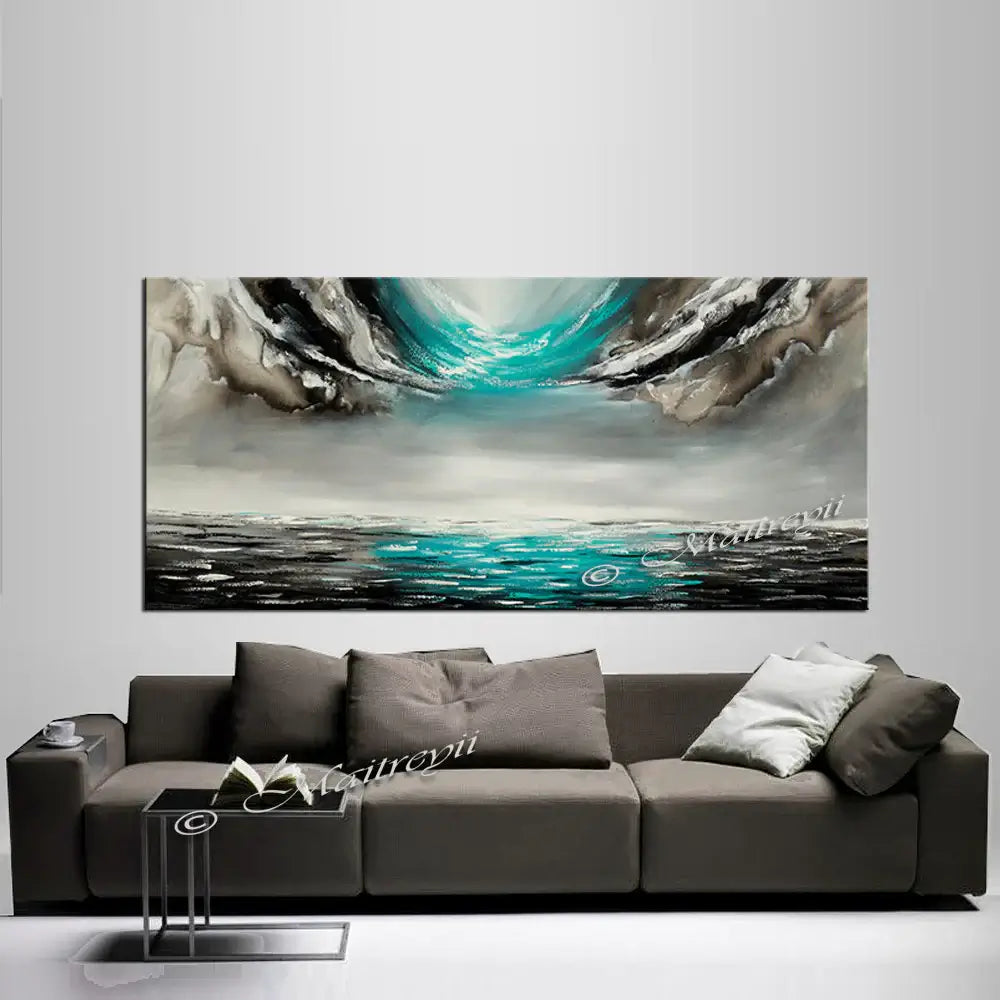 Large Ocean Art Teal Turquoise Paintings displayed above a modern sofa, showcasing tranquil ocean waves and serene colors.