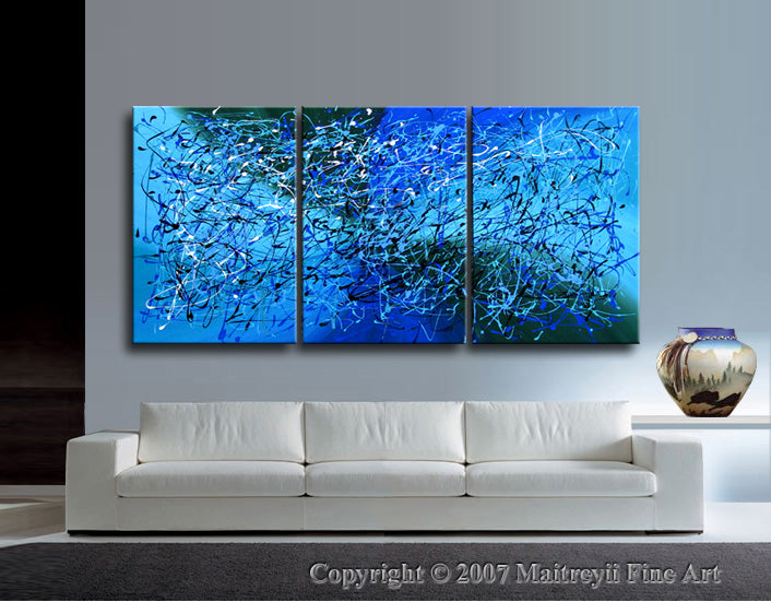 Abstract Canvas Wall Art featuring an extra large modern painting in blue hues, displayed above a white sofa.