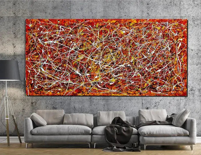 Red Painting Jackson Pollock Style artwork displayed above a modern sofa, showcasing vibrant red tones and abstract textures.