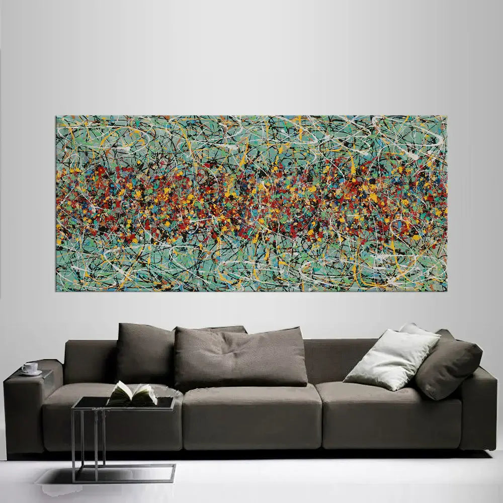 Drip painting on canvas displayed above a gray sofa in a modern living room, featuring vibrant colors and dynamic patterns.