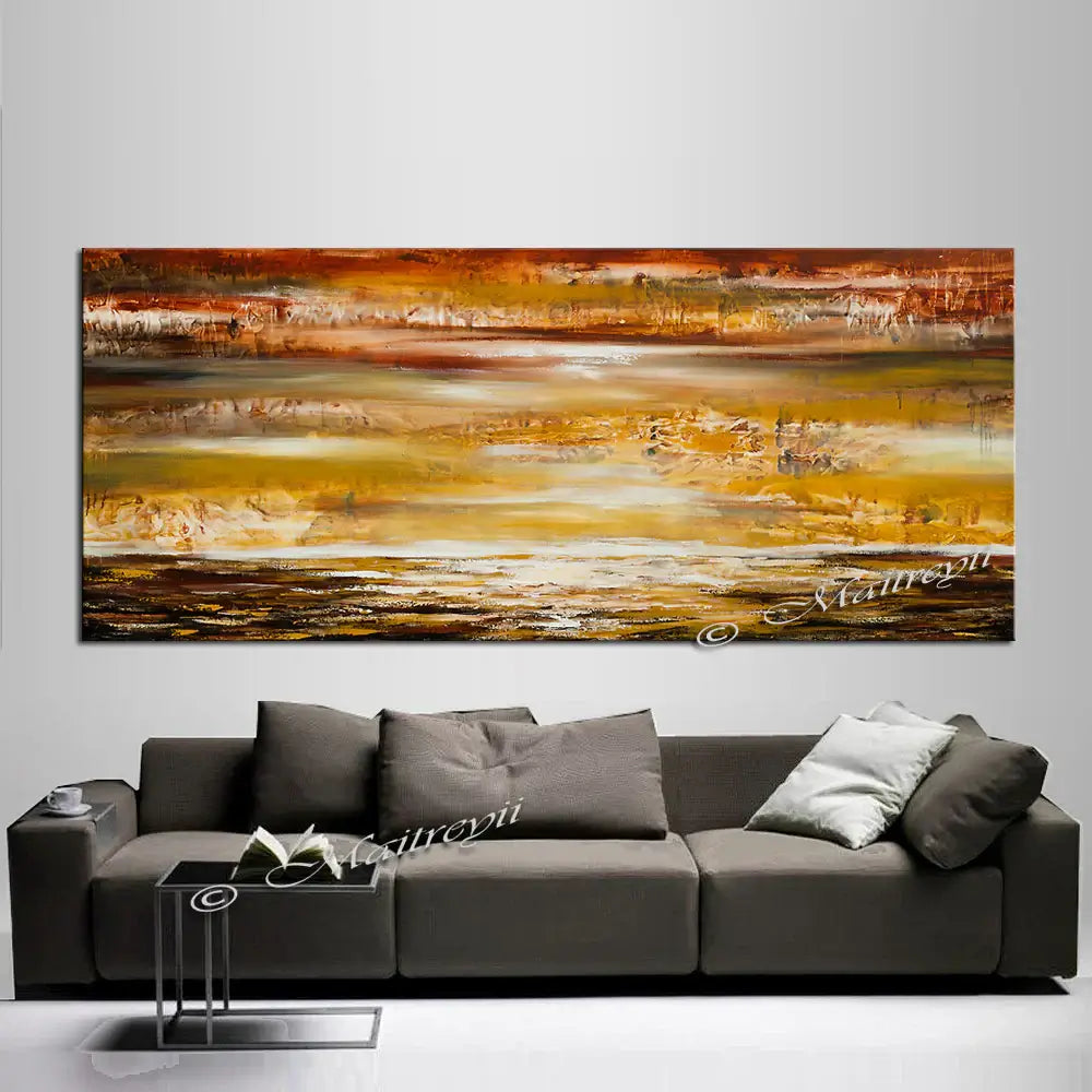 Large Ocean Art Oil Painting above a modern gray sofa, showcasing warm gold and brown abstract seascape by Maitreyii.