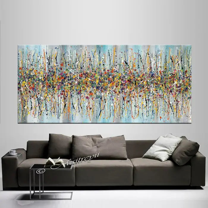 Jackson Pollock canvas art showcasing vibrant abstract painting above a modern sofa in a stylish living room.