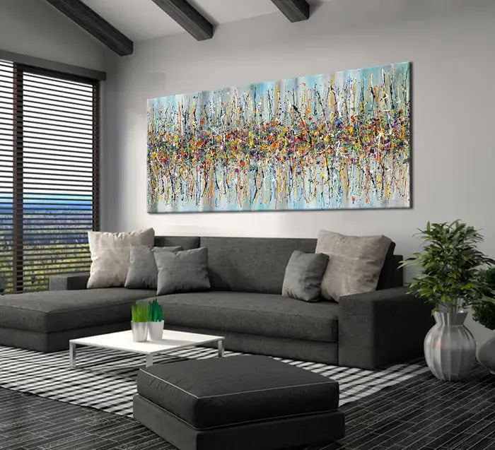 Jackson Pollock canvas art displayed above a modern gray couch in a stylish living room.