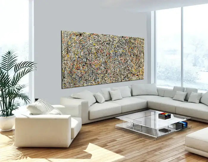 Abstract canvas art hanging on a light wall in a modern living room, enhancing the decor with vibrant colors.