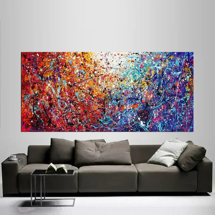 Large modern abstract painting in Jackson Pollock style featuring vibrant colors and textured abstract art on a living room wall.