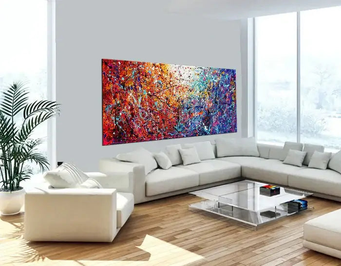 Large textured abstract art painting in a bright living room featuring bold colors and a modern design.