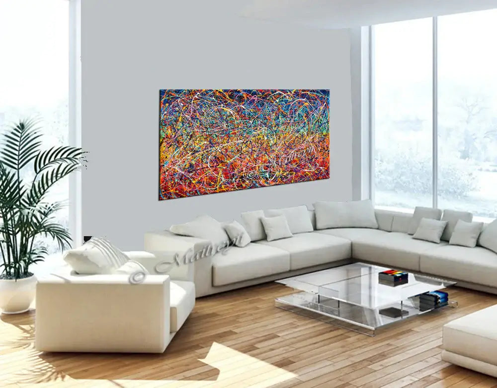 Painting Jackson Pollock displayed in a bright, modern living room with white furniture and large windows.