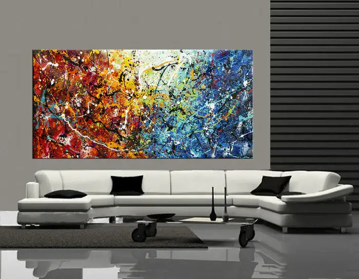 Abstract Jackson Pollock handmade drip painting displayed above a modern white sofa in a stylish interior.