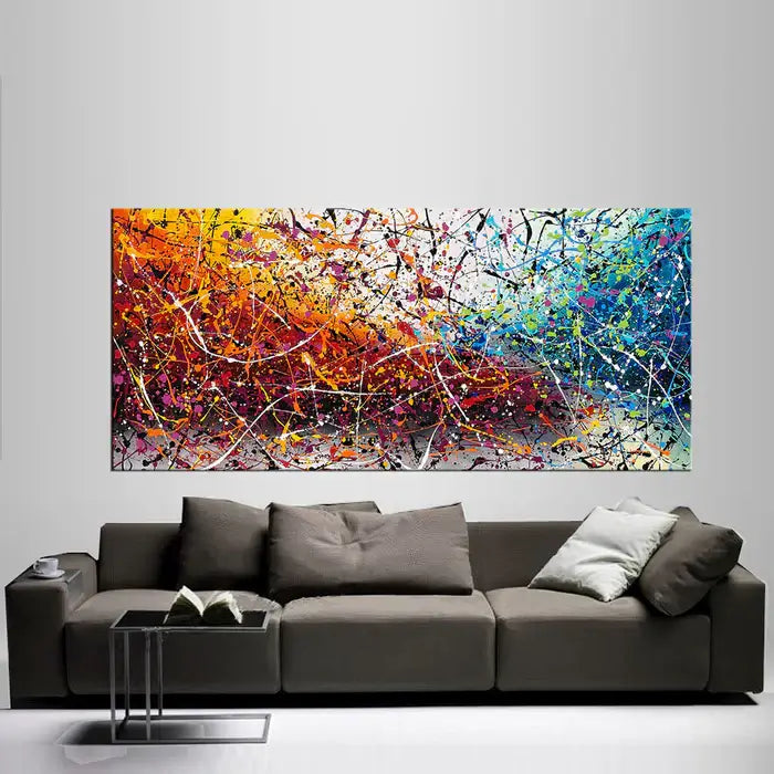 Painting Jackson Pollock Multiple Size displayed above a modern sofa, showcasing vibrant colors and abstract drip art.