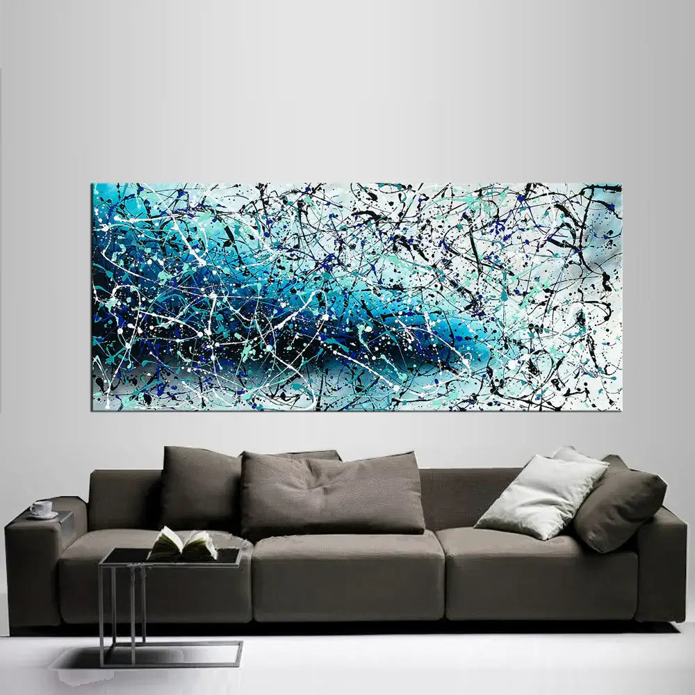 Painting Jackson Pollock Art displayed above a modern sofa in a stylish living room, showcasing vibrant colors and abstract expressionism.