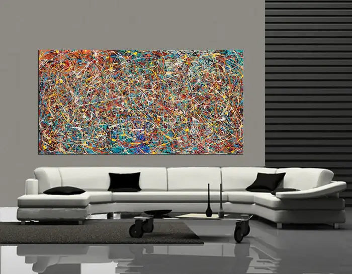 Modern splatter art painting displayed in a contemporary living room with sleek furniture and vibrant colors.