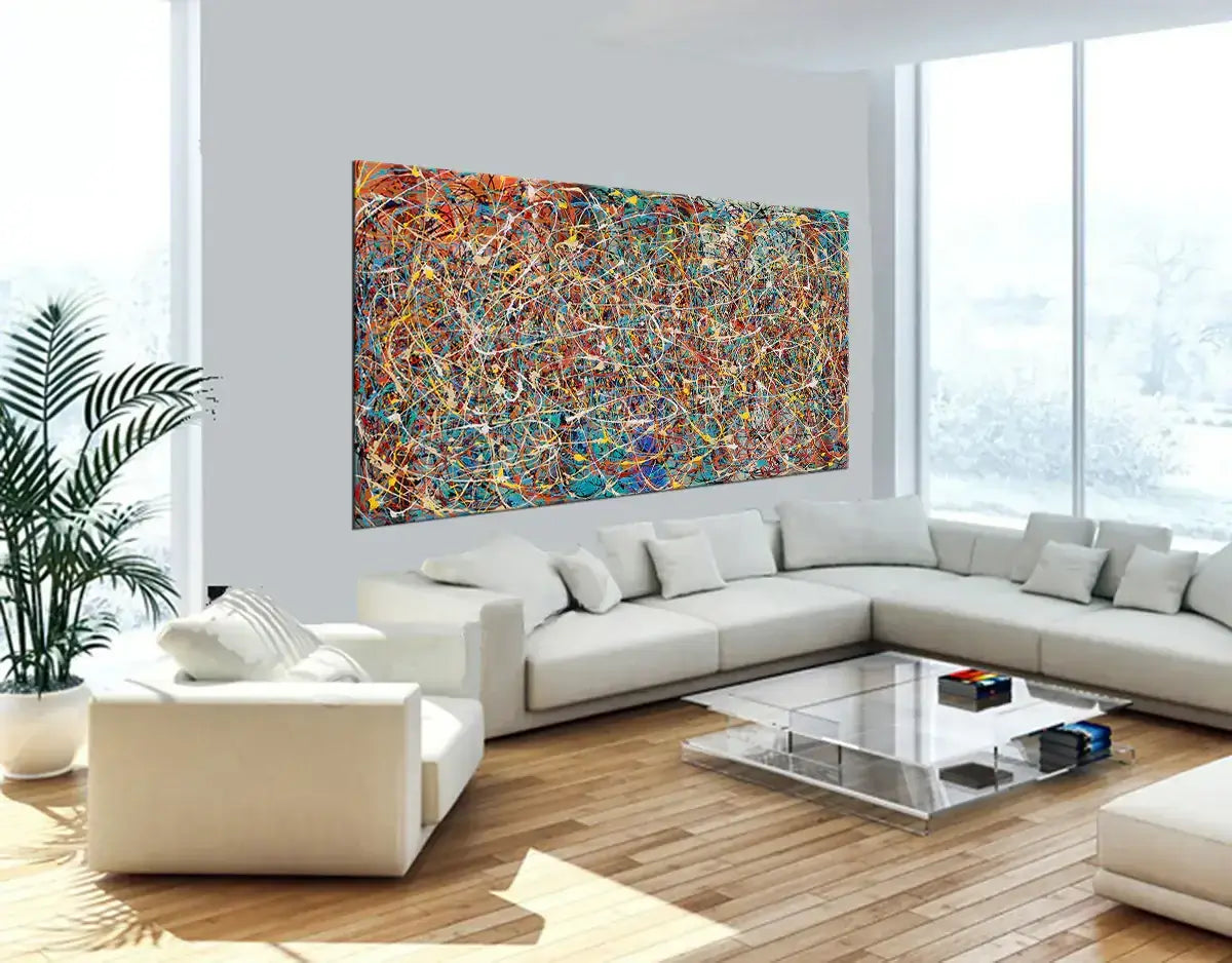 Modern splatter art painting displayed in a stylish living room, showcasing vibrant colors and abstract design.