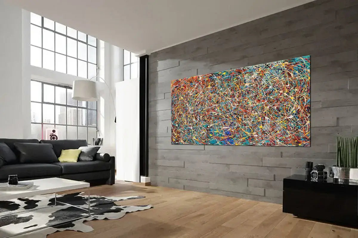 Modern splatter art painting displayed in a stylish living room featuring vibrant colors and dynamic textures on canvas.