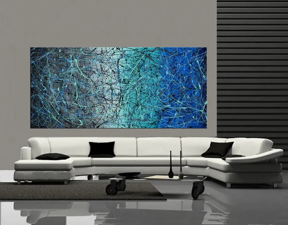 Pollock Inspired Wall Art showcased above a modern white couch in a stylish living room setting.