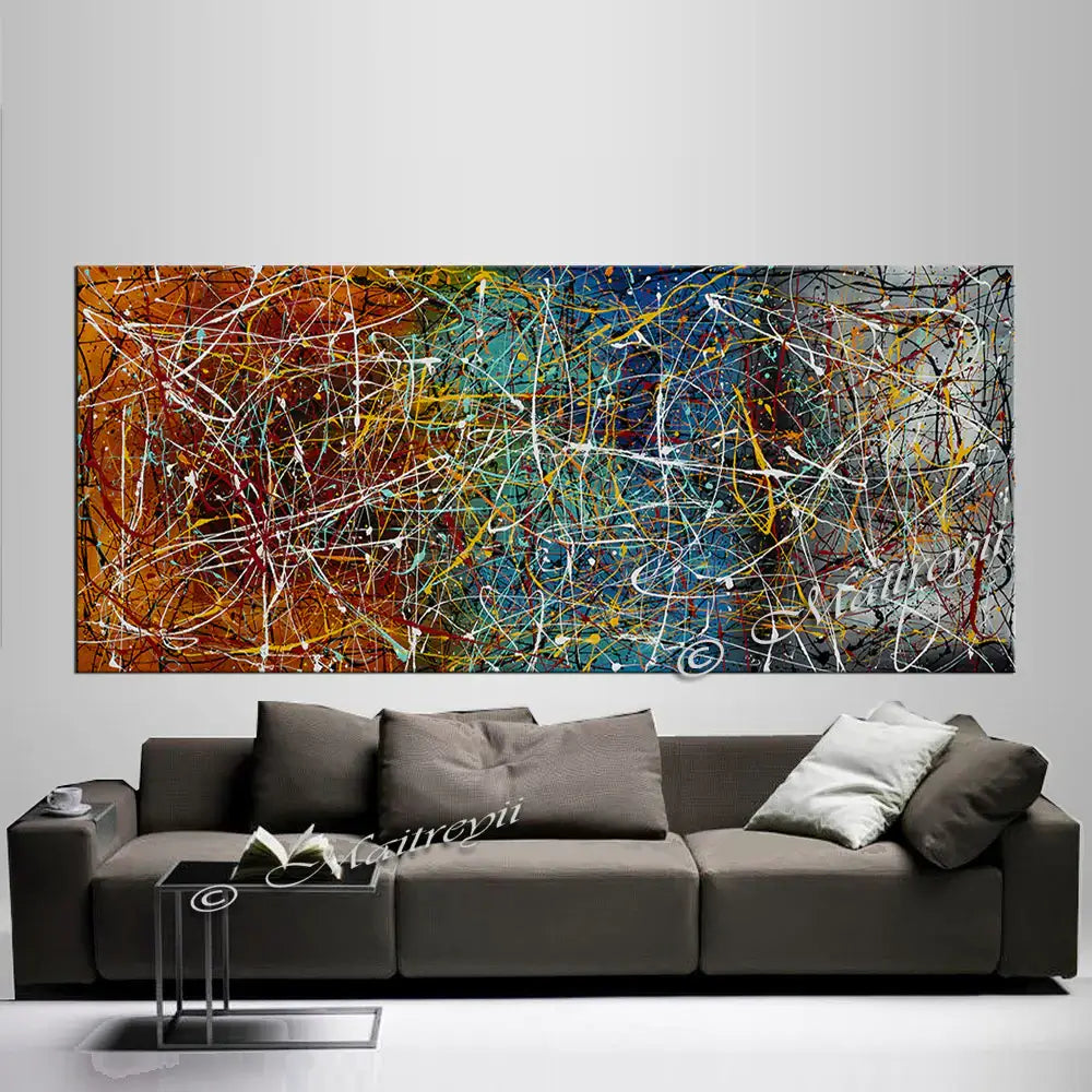 Drip Painting on Canvas displayed above a modern couch, featuring vibrant colors and dynamic abstract patterns.