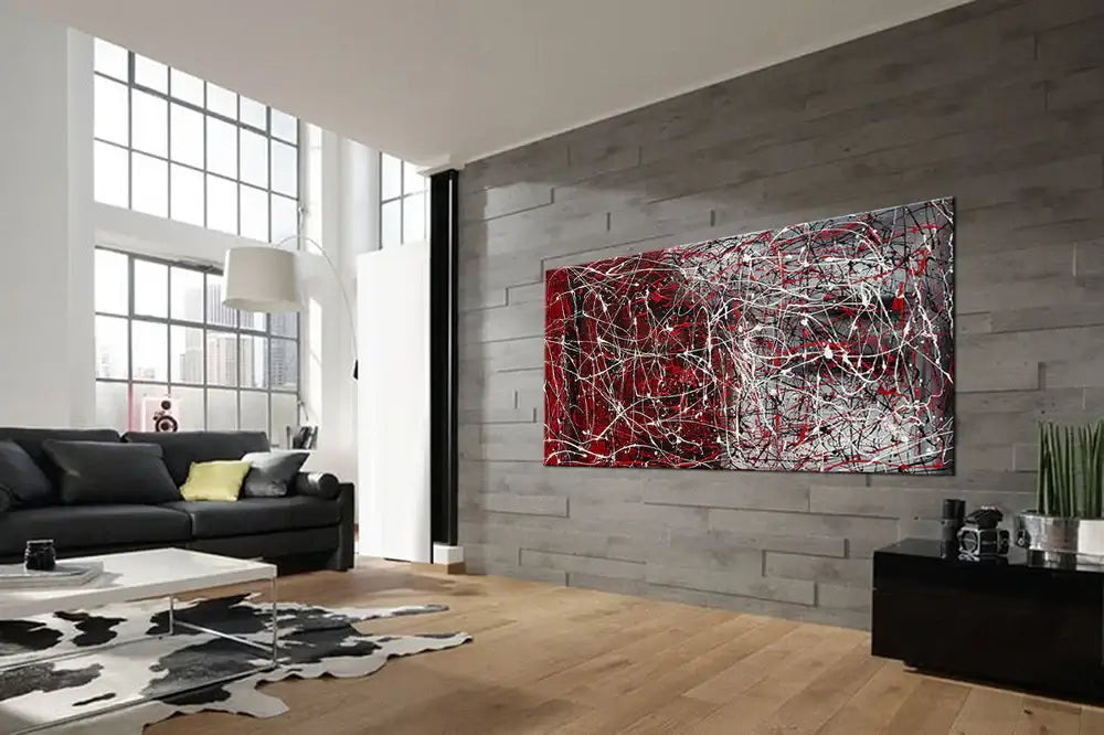 Drip painting on canvas displayed in a modern living room with gray walls and stylish furniture.