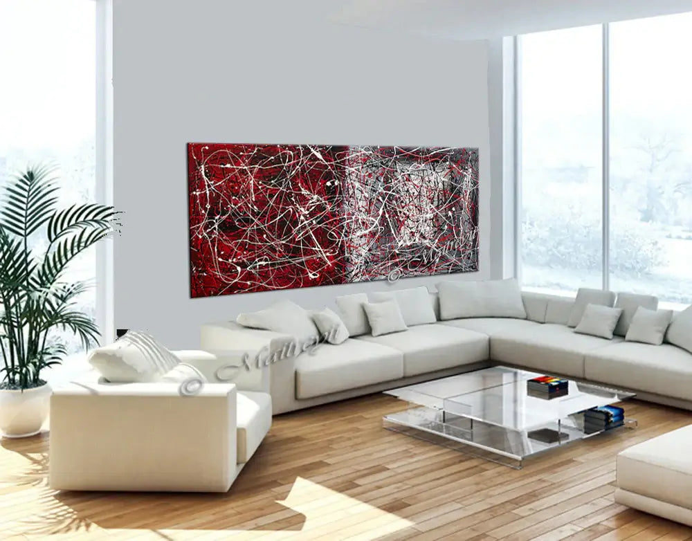 Oversize abstract canvas art in Jackson Pollock Style displayed in a modern living room with white furniture.