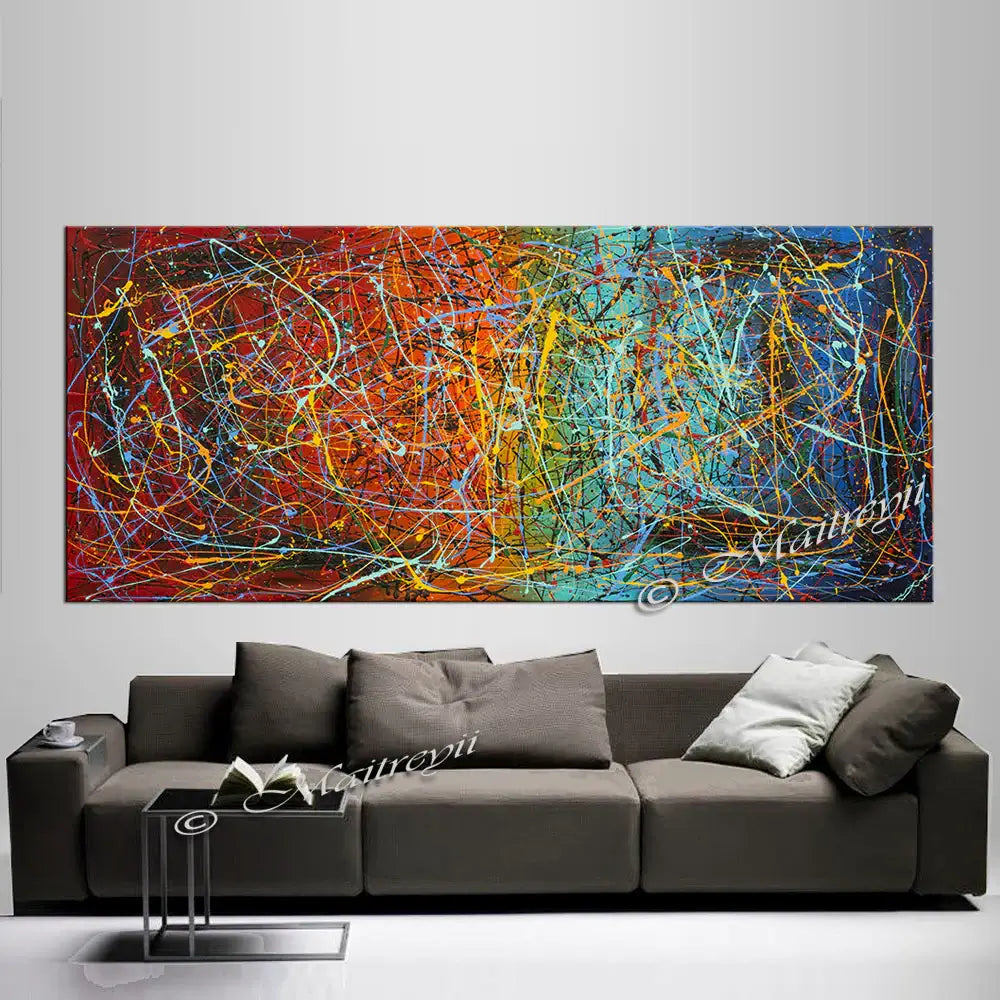 Jackson Pollock Style abstract canvas wall art featuring vibrant colors and bold textures above a modern sofa.
