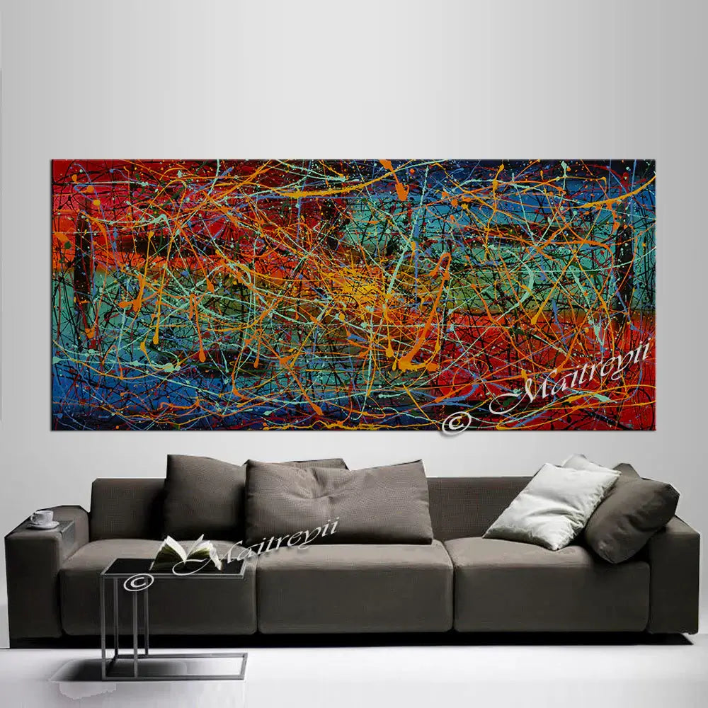 Jackson Pollock Style abstract canvas wall art displayed above a modern sofa, showcasing bold colors and expressive textures.