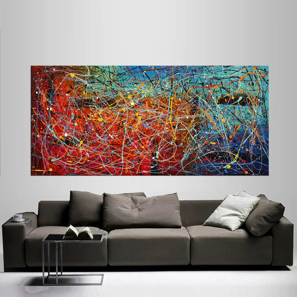 Jackson Pollock Style Painting displayed on a modern wall behind a stylish sofa, showcasing vibrant abstract drip art.