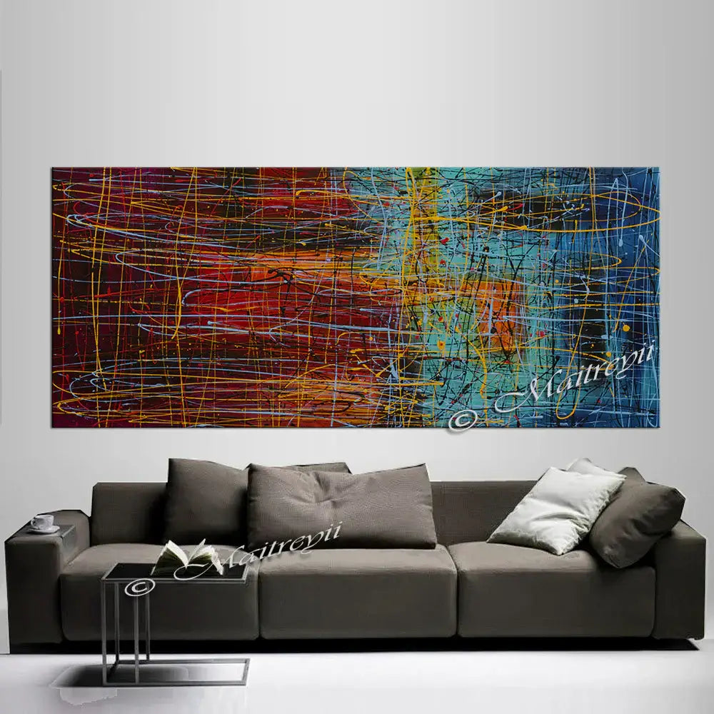Jackson Pollock Style abstract canvas wall art above modern couch in living room setting.