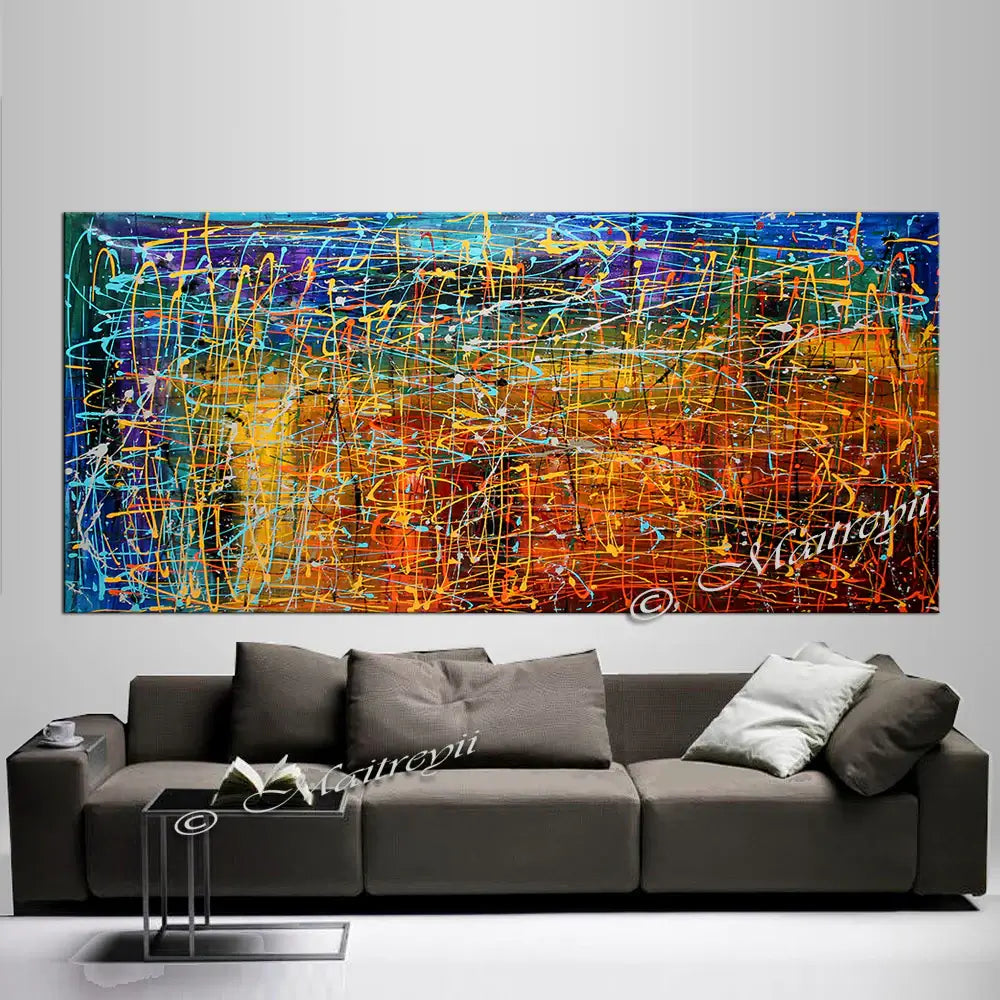 Jackson Pollock Style artwork above a modern sofa in a luxury home interior, showcasing vibrant colors and dynamic movement.