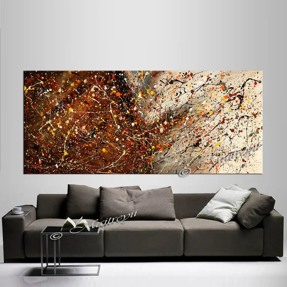 Hand-painted abstract canvas artwork in warm colors above a modern sofa, ideal for home decor.