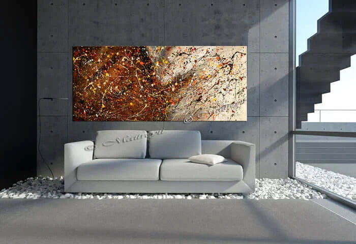 Abstract hand-painted canvas art in modern living room, featuring bold colors and unique texture on a concrete wall.
