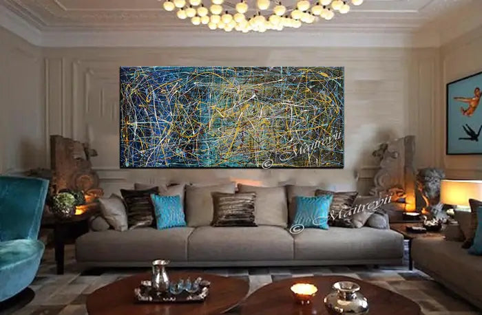 Abstract art – modern hand-painted canvas displayed in a stylish living room with blue and gold accents.