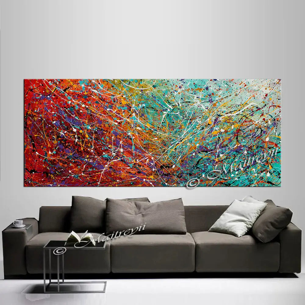 Pollock inspired wall art above a modern gray sofa, showcasing vibrant colors and dynamic abstract design.