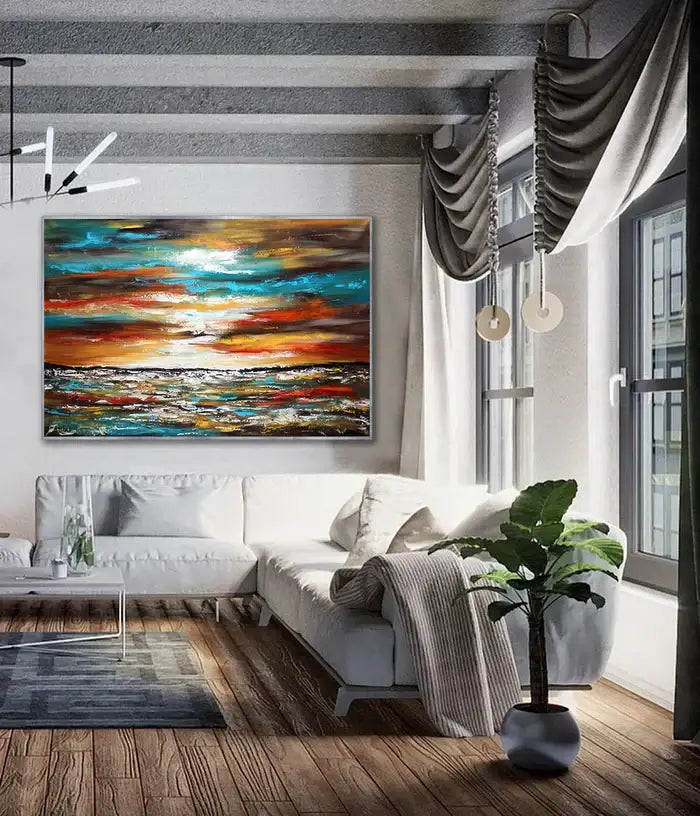 Large ocean art oil painting in modern living room with white couch and greenery, showcasing vibrant sunset colors.