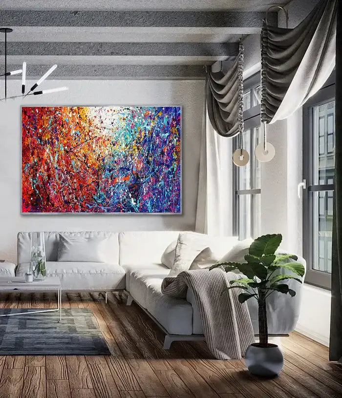 Painted abstract art displayed in a modern living room featuring vibrant colors, texture, and a stylish interior.