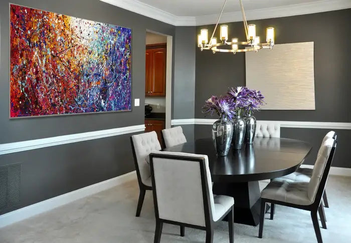 Painted abstract art on a modern dining room wall, adding color and texture to the stylish interior.
