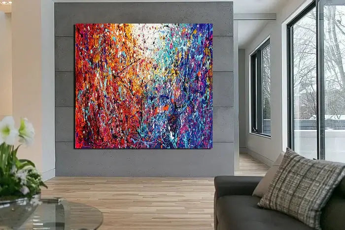 Painted abstract art featuring vibrant colors and textures displayed in a modern living space.