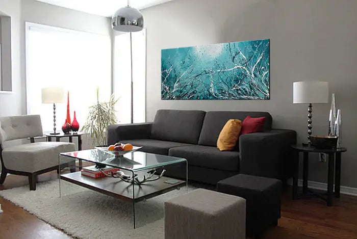 Abstract Teal Painting hanging above a modern living room sofa, showcasing vibrant teal tones and abstract design.